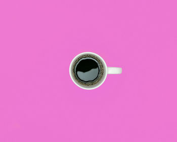 Directly above shot of coffee on yellow background
