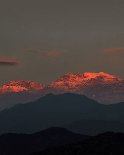 Scenic view of silhouette mountains against sky during sunset