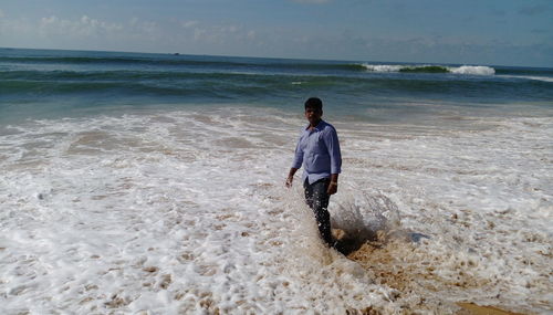 Full length of man standing on beach