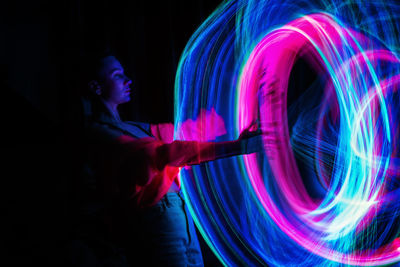 Man spinning wire wool at night