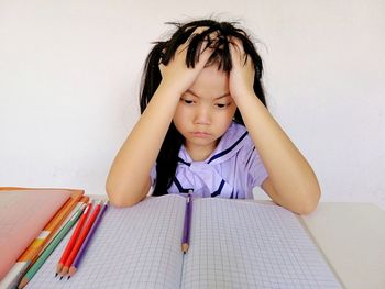 Sad girl sitting on table