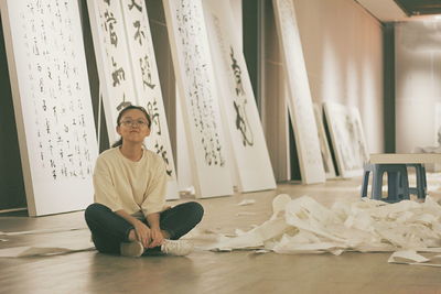 Portrait of man sitting on paper