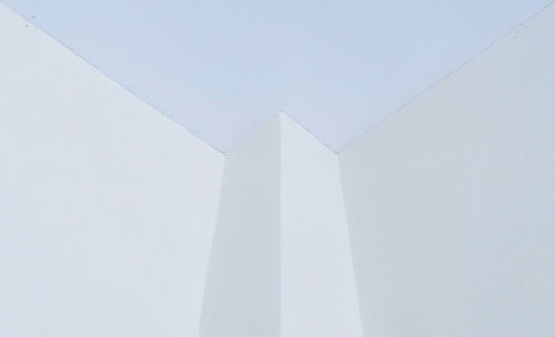 High section of white built structure against sky