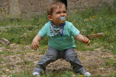 Cute boy playing on field