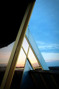 Low angle view of glass window against sky