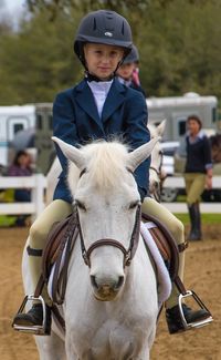 Portrait of boy riding horse