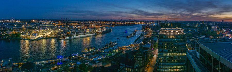 High angle view of illuminated city buildings at dusk