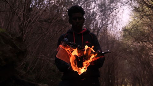 Man with fire crackers in the forest