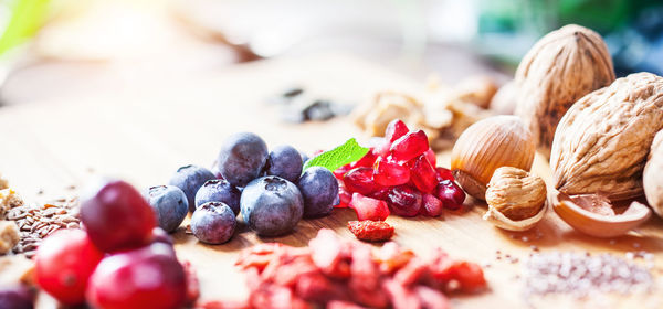 Close-up of fruits and seeds on wooden table