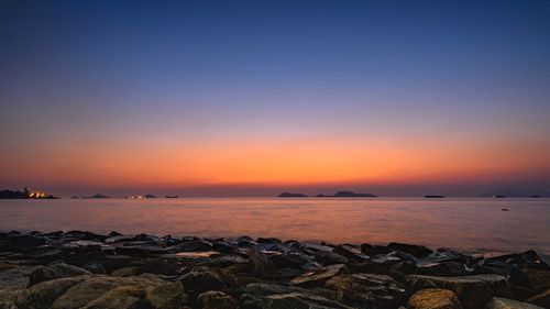 Scenic view of sea against clear sky during sunset