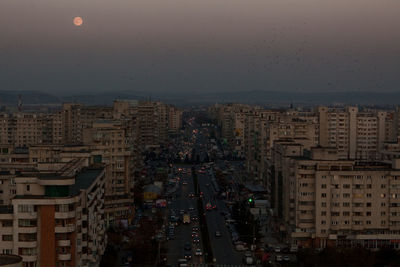 High angle view of illuminated city buildings at dusk