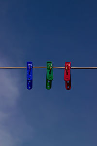Low angle view of traffic signal against blue sky