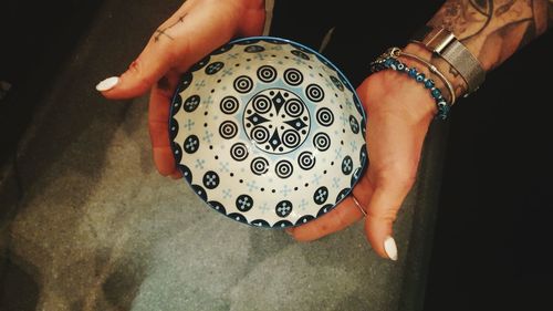 Cropped image of hand holding bowl