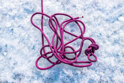 Directly above shot of pink rope on snow