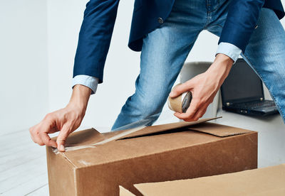 Low section of man working on box