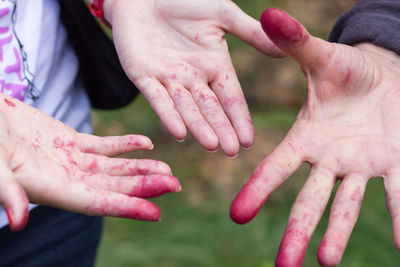 Cropped image of hands with painted fingers