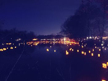 Illuminated city against sky at night