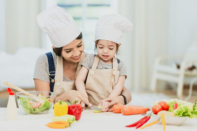 Midsection of woman having food at home