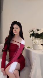 Portrait of young woman standing against wall