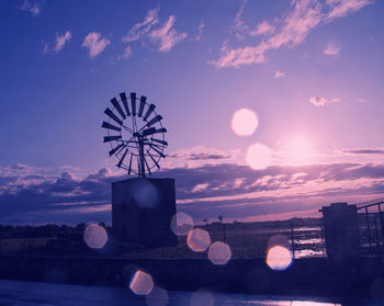 Low angle view of silhouette ferris wheel against sky after thunder storm 