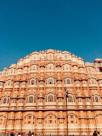 Low angle view of building against clear blue sky