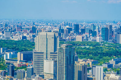 High angle view of modern buildings in city against sky