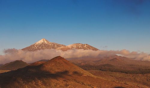 Scenic view of mountains against clear blue sky