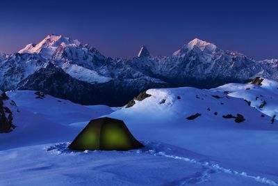 Scenic view of snow covered mountains against sky