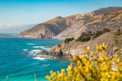 Scenic view of sea and mountains against sky