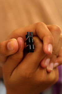 Cropped hand of person holding binder clip