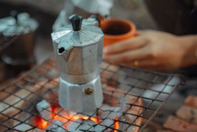 Close-up of hand holding coffee cup