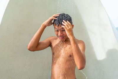 Full length of shirtless boy in water