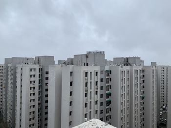 Buildings in city against sky