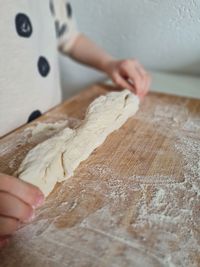 Close-up of hand holding bread on table