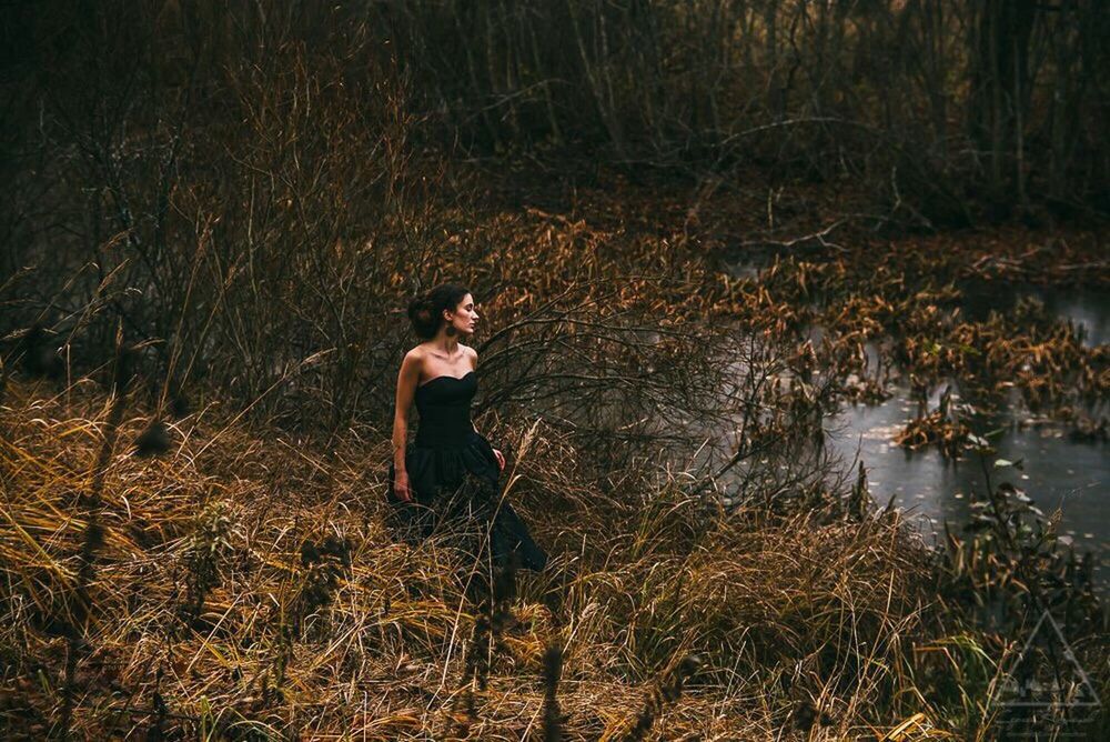 water, standing, lake, grass, lifestyles, tranquility, nature, leisure activity, full length, forest, plant, tree, lakeshore, outdoors, three quarter length, tranquil scene, side view, beauty in nature