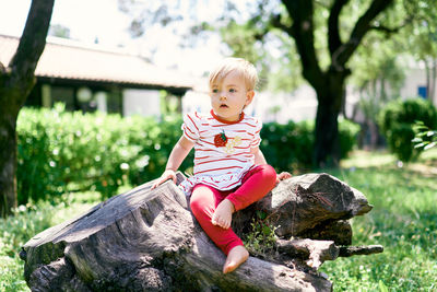 Portrait of cute girl sitting outdoors
