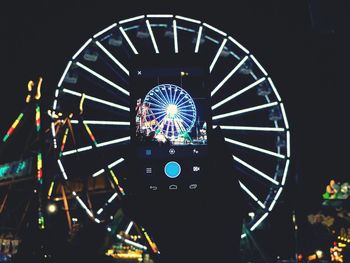 Low angle view of illuminated ferris wheel