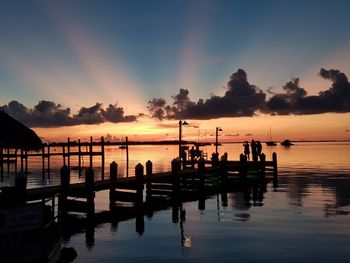 Silhouette pier on sea against sky during sunset