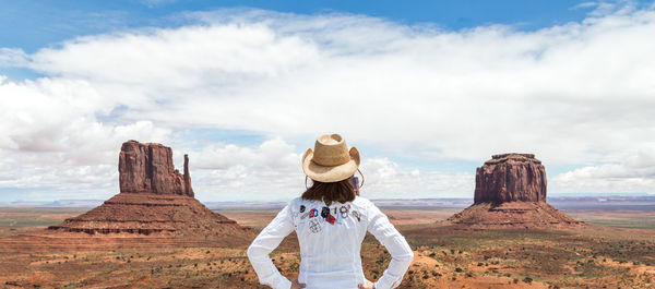 Rear view of tourists on rock