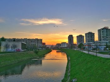 Scenic view of city against sky at sunset