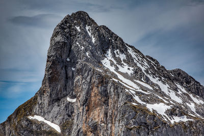 Low angle view of snowcapped mountain against sky