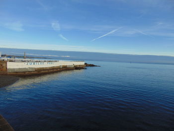 Scenic view of sea against blue sky