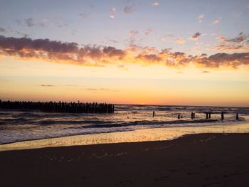 Scenic view of beach against sky during sunset