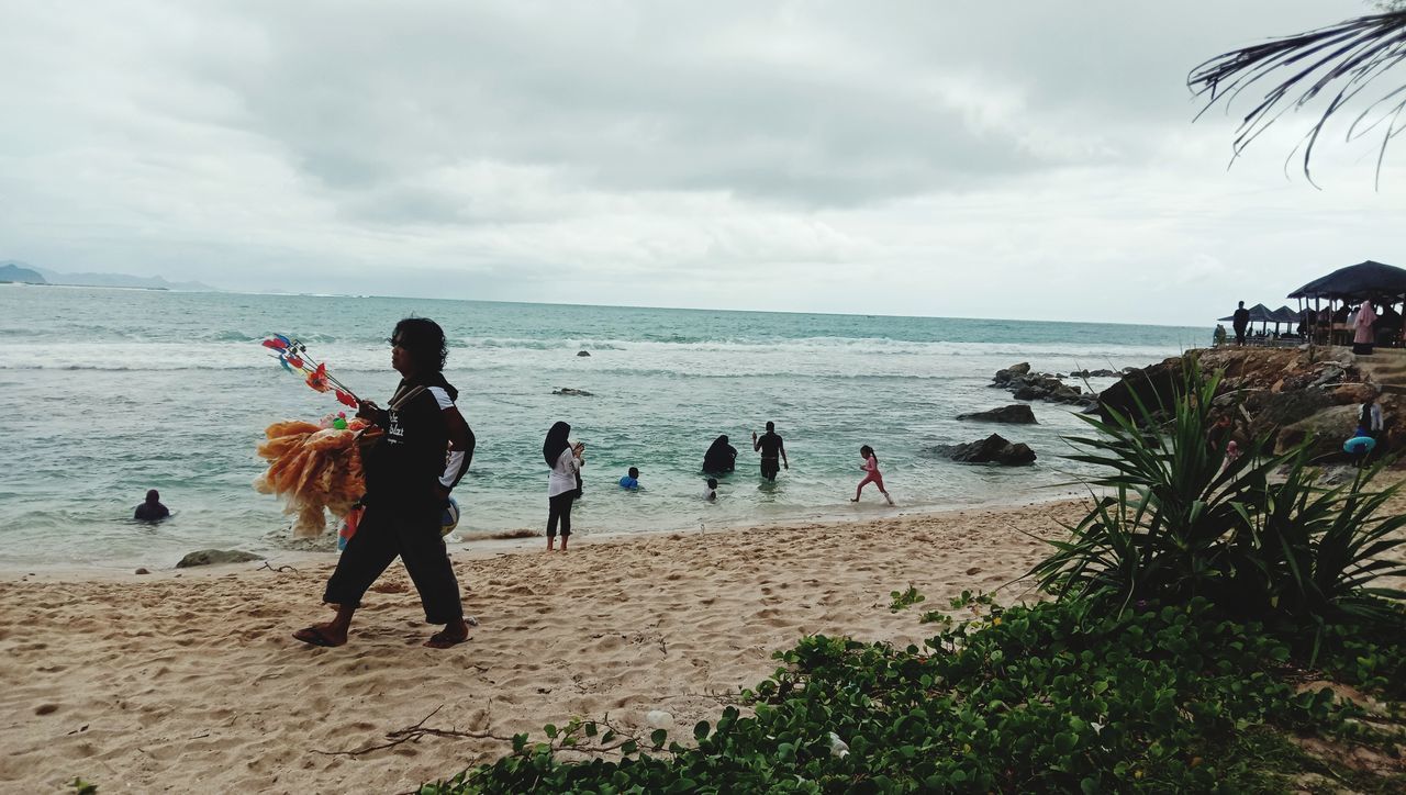 GROUP OF PEOPLE ON BEACH