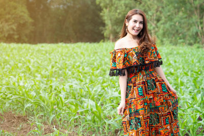 Portrait of a smiling young woman standing outdoors