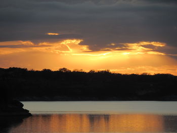 Scenic view of lake against orange sky