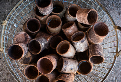 High angle view of old clay glasses in basket