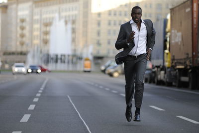 Full length of a man running on road