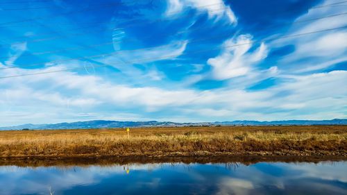 Reflective bay area marshlands against the blue california sky.