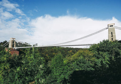 Low angle view of suspension bridge against sky